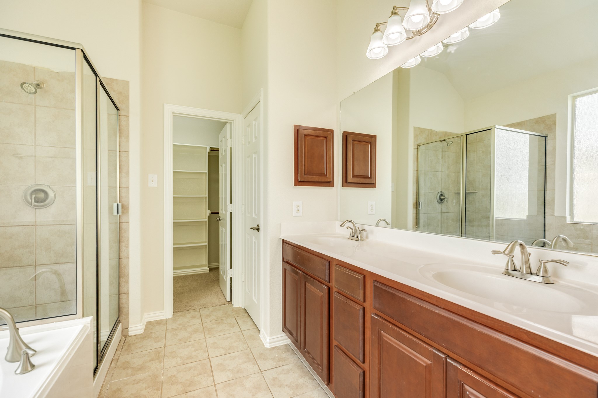 13417 Star Creek Lane Rosharon, TX 77583 - Photo 20 of 41 Primary bathroom has double vanities, a soaking tub, a glass walk-in shower, and a large walk-in closet.