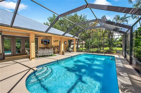 a view of a patio with a table and chairs under an umbrella