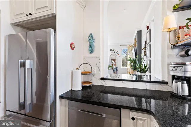 a kitchen with appliances a sink and cabinets