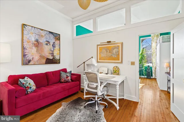 a living room with furniture and wooden floor