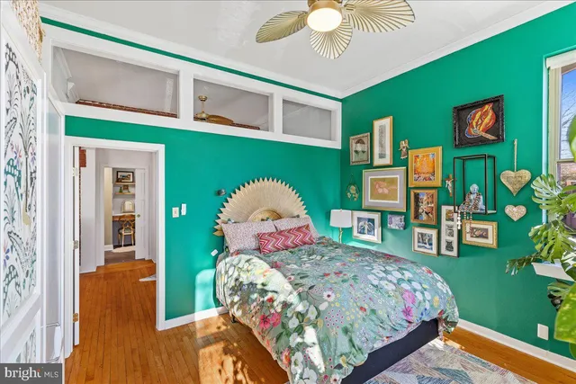 a bedroom with a bed window and dresser