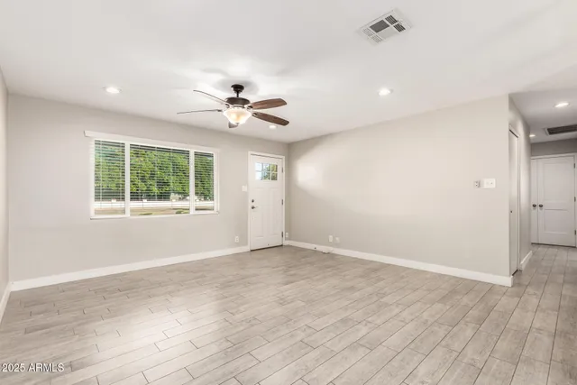 wooden floor in an empty room with a window