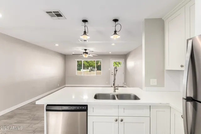 a view of a kitchen with a sink and a window