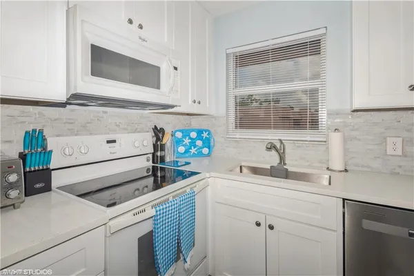 a kitchen with appliances cabinets and a sink
