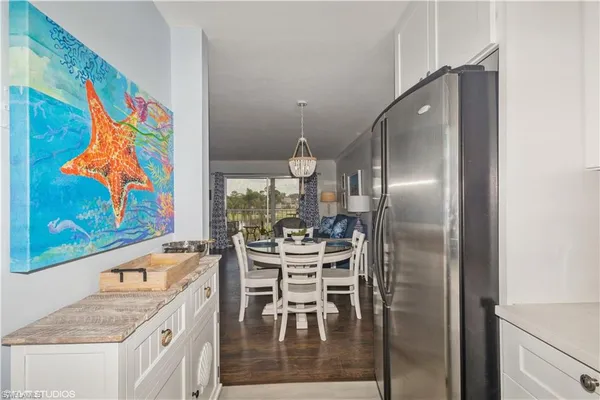 a kitchen with stainless steel appliances granite countertop a refrigerator and a stove