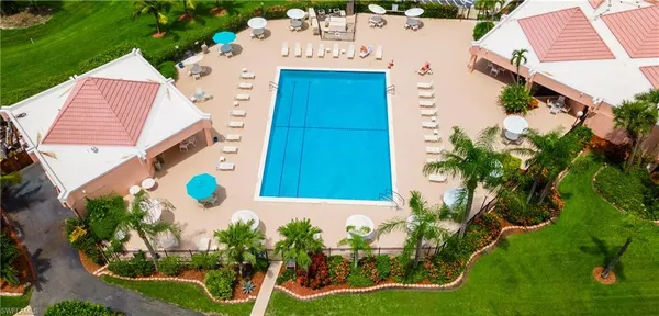 an aerial view of a house with a garden and swimming pool