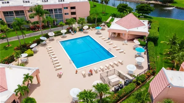 an aerial view of a house with garden space and lake view