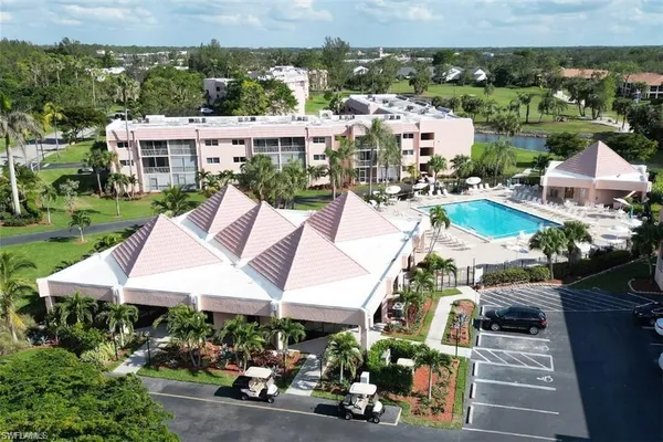 an aerial view of a house with a yard basket ball court and outdoor seating