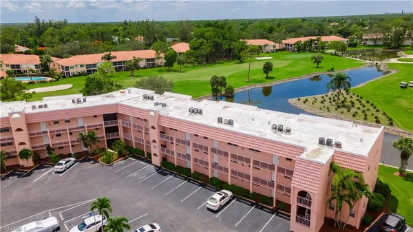 a view of a building with garden space and street view
