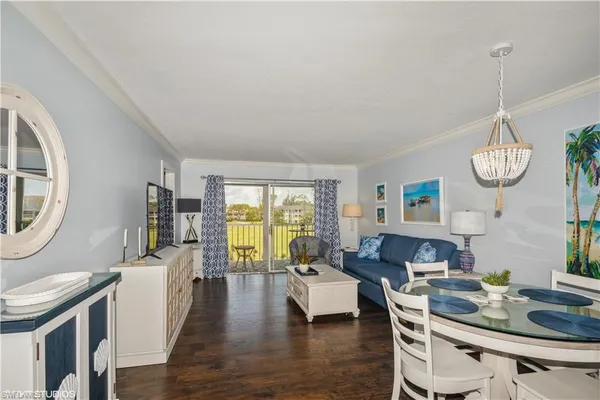 a living room with furniture a rug and a window