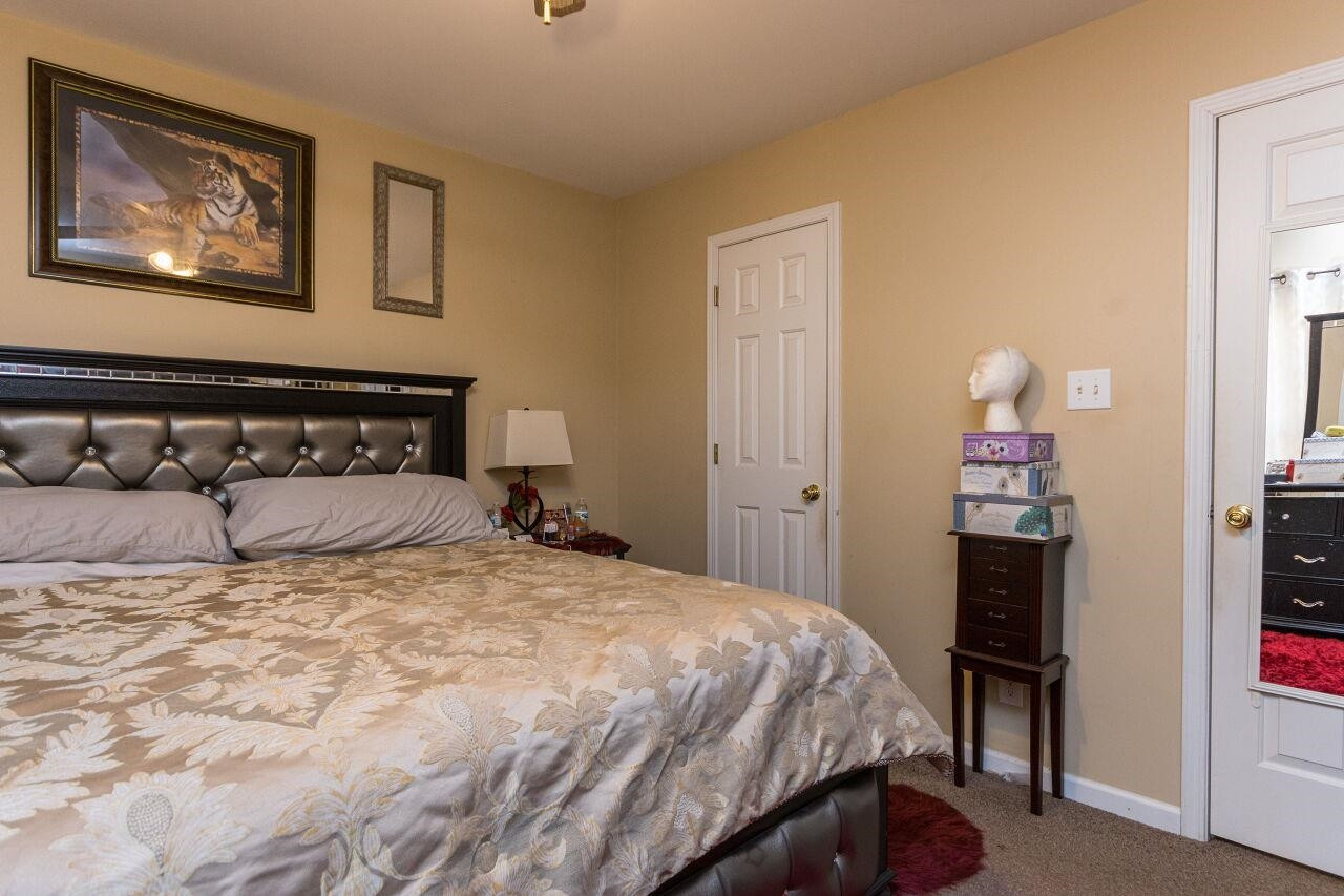 4802 Parkville Drive Raleigh, NC 27604 - Photo 11 of 15 a bedroom with a bed and a painting on the wall