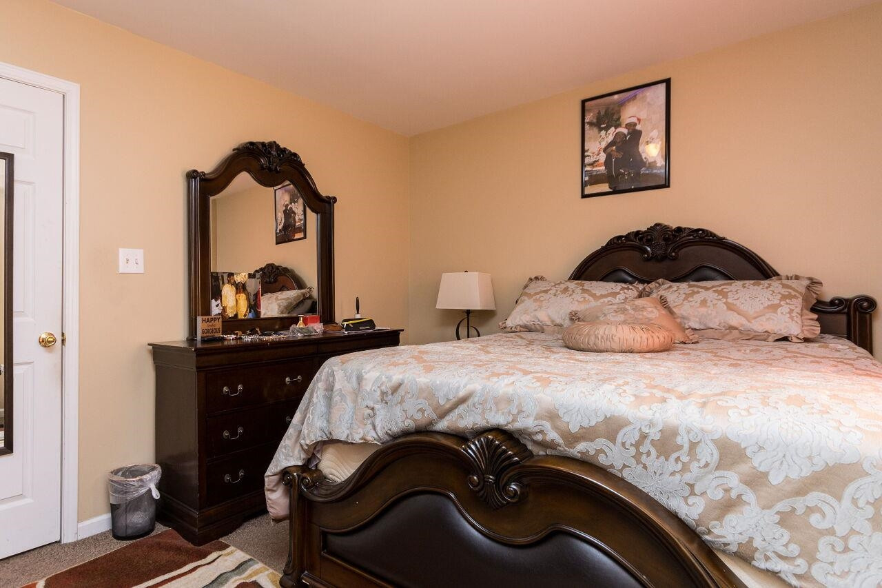 4802 Parkville Drive Raleigh, NC 27604 - Photo 13 of 15 a bedroom with a bed and wooden floor