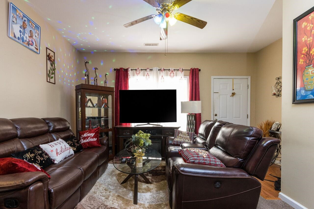 4802 Parkville Drive Raleigh, NC 27604 - Photo 5 of 15 a living room with furniture and a flat screen tv