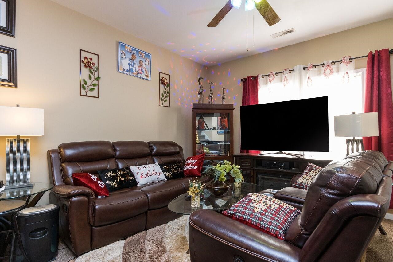 4802 Parkville Drive Raleigh, NC 27604 - Photo 6 of 15 a living room with furniture and a flat screen tv