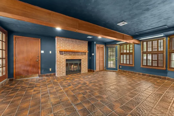 a view of an empty room with a fireplace