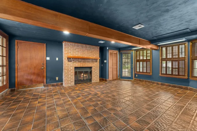 a view of an empty room with a fireplace