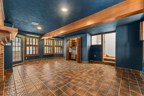 an empty room with window and ceiling fan