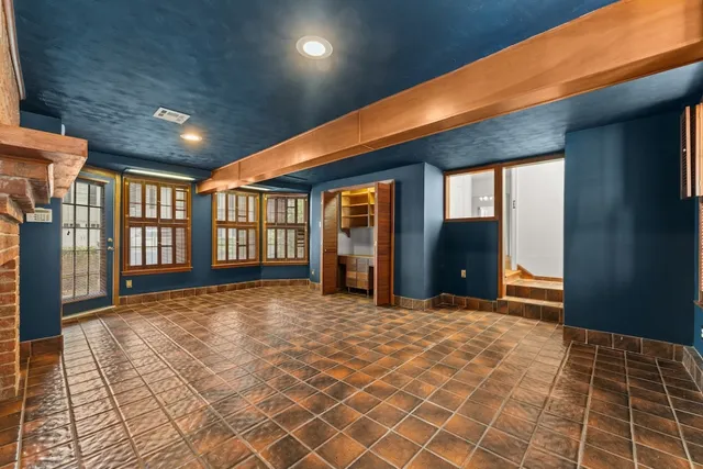 an empty room with window and ceiling fan