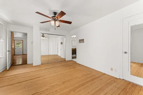 a bathroom with a granite countertop toilet sink and mirror