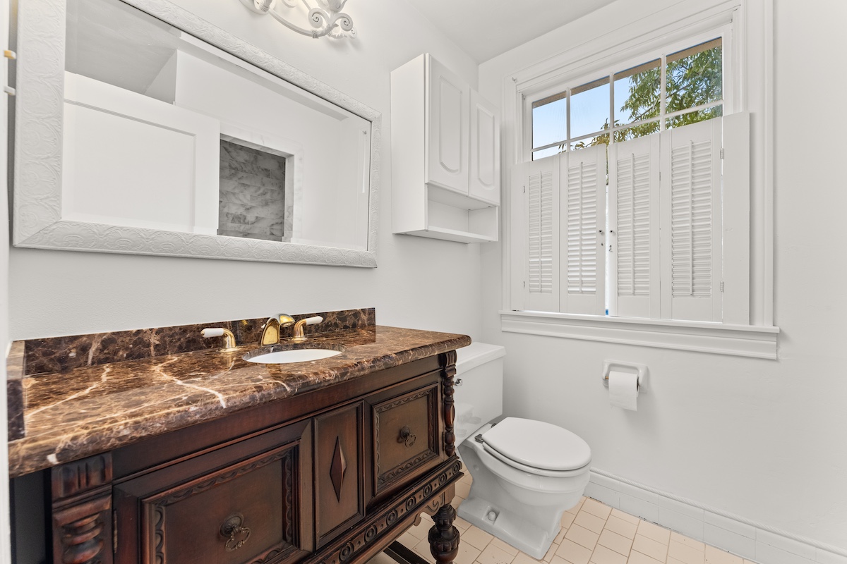 2534 Harris Boulevard Austin, TX 78703 - Photo 18 of 26 a bathroom with a granite countertop toilet sink and mirror