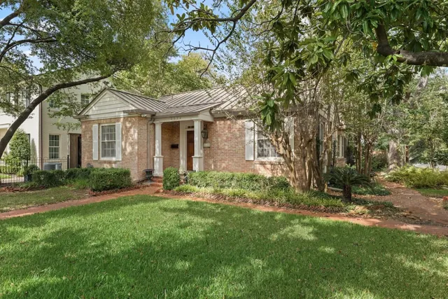 a front view of a house with a garden and yard