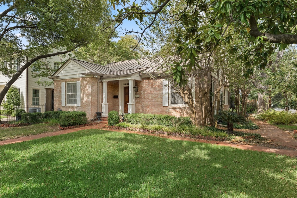 2534 Harris Boulevard Austin, TX 78703 - Photo 2 of 26 a front view of a house with a garden and yard