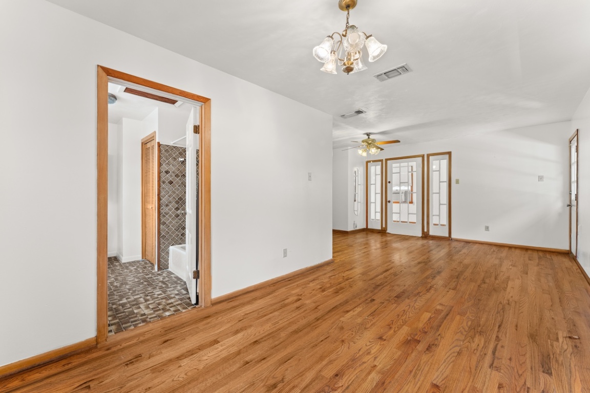 2534 Harris Boulevard Austin, TX 78703 - Photo 23 of 26 a view of an empty room with wooden floor and a window