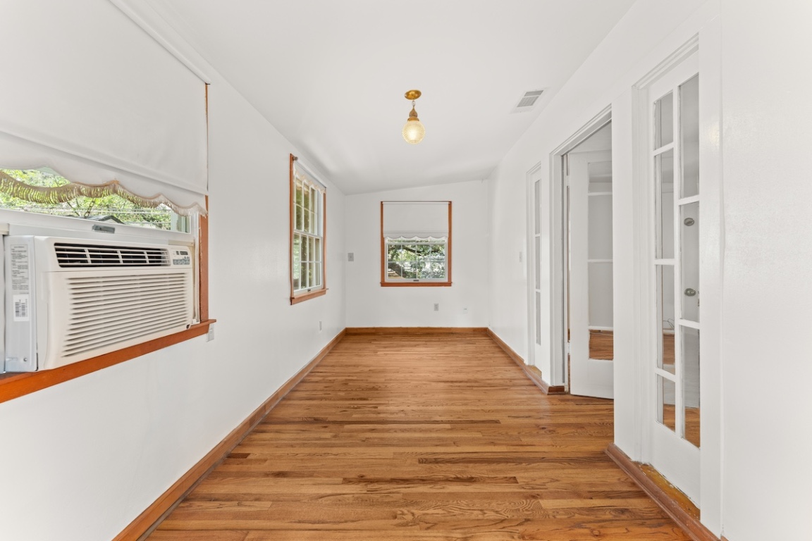 2534 Harris Boulevard Austin, TX 78703 - Photo 24 of 26 a view of an empty room with wooden floor and a window