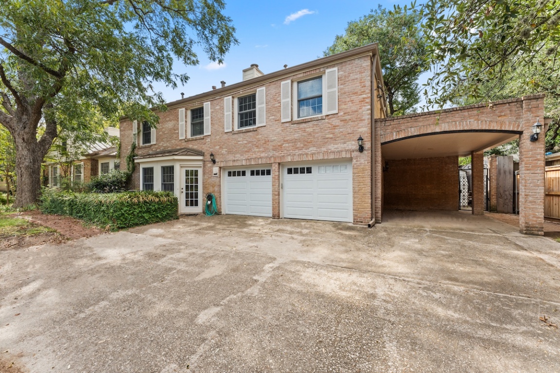 2534 Harris Boulevard Austin, TX 78703 - Photo 26 of 26 a front view of a house with a yard and garage