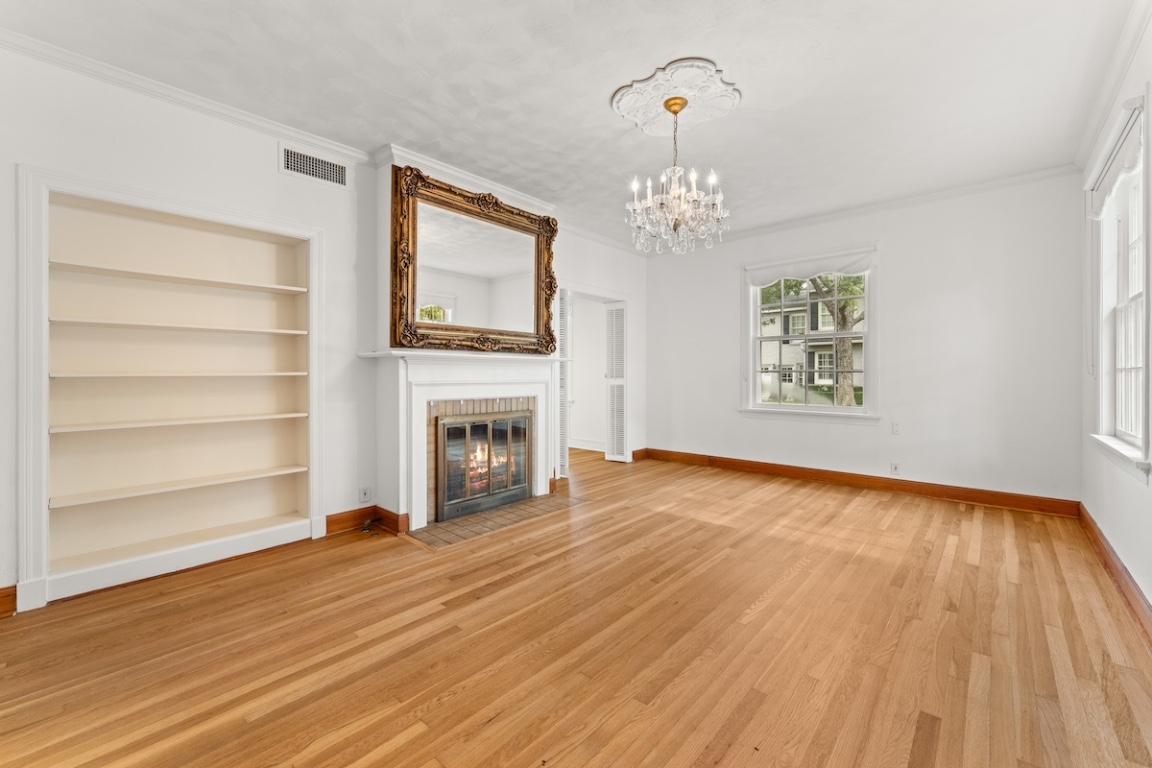 2534 Harris Boulevard Austin, TX 78703 - Photo 3 of 26 a view of a livingroom with wooden floor fireplace and a window