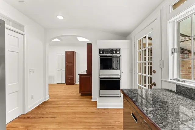 a kitchen with stainless steel appliances granite countertop a refrigerator and a sink