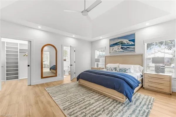 a bedroom with a large bed and a window
