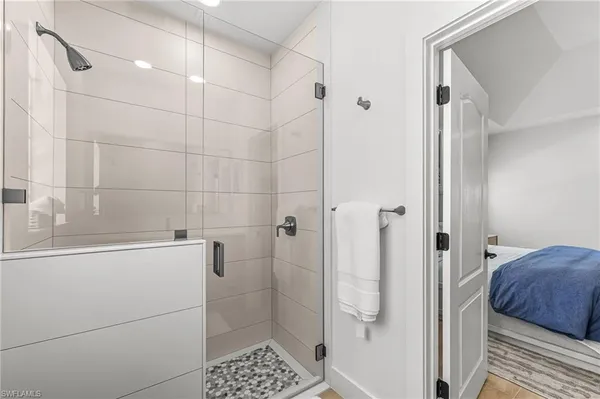 a bathroom with a shower and a sink