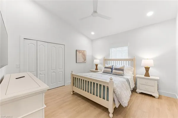 a bedroom with a bed and a night stand