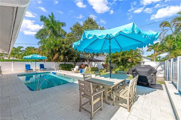 a patio with a patio table and chairs