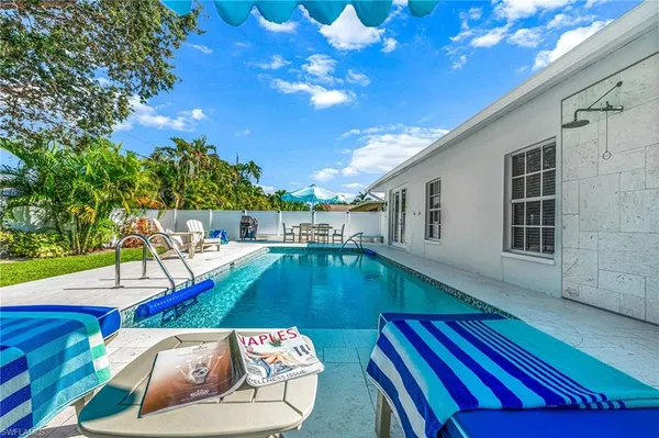 a view of swimming pool with seating area
