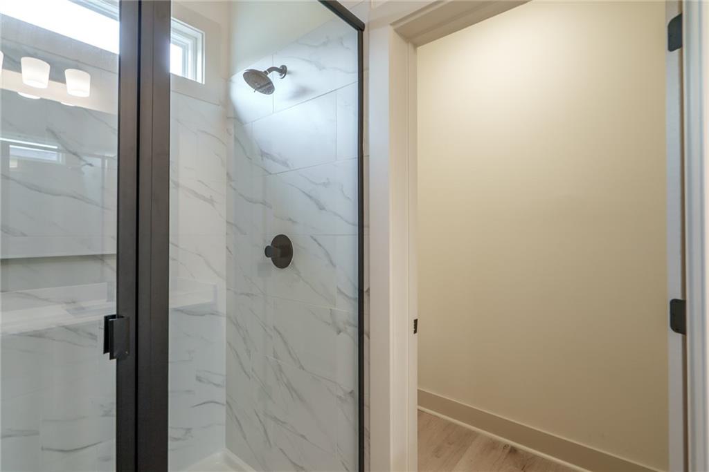 205 Squirrel Run Good Hope, GA 30641 - Photo 20 of 50 a bathroom with a glass shower door