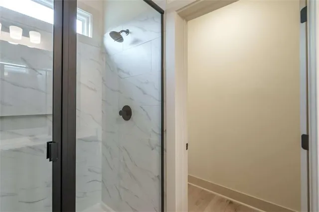 a bathroom with a glass shower door