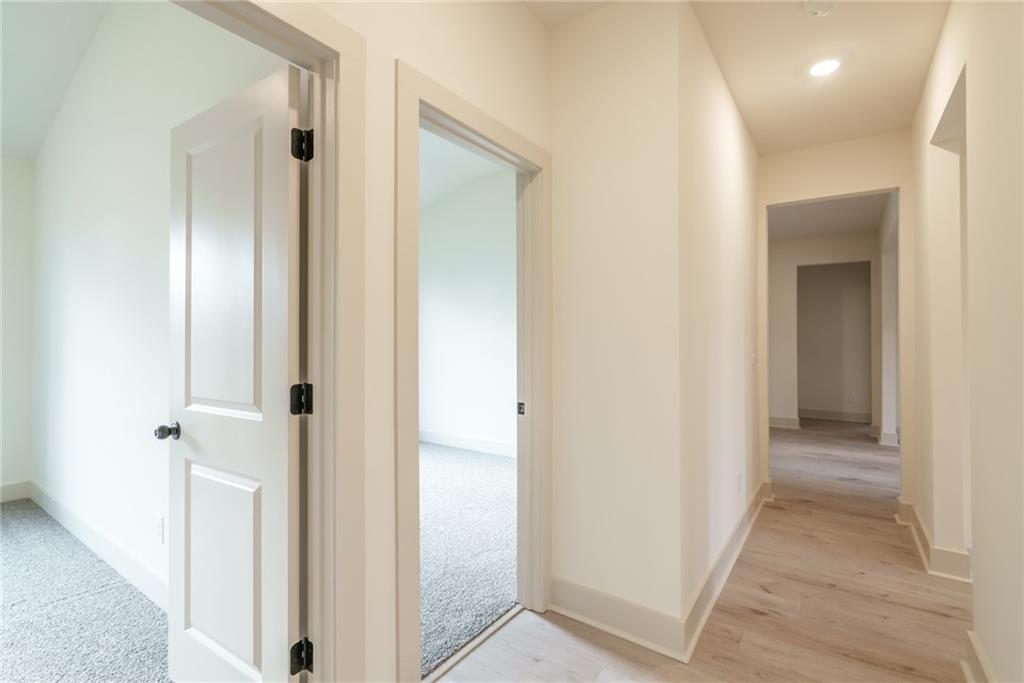 205 Squirrel Run Good Hope, GA 30641 - Photo 23 of 50 a view of a hallway with wooden floor