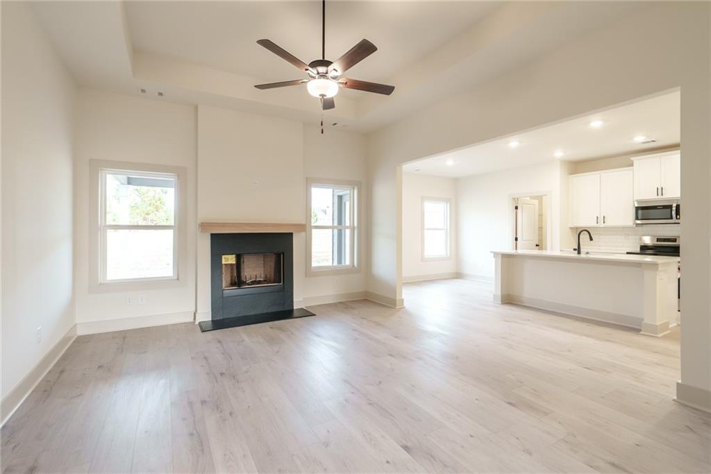 205 Squirrel Run Good Hope, GA 30641 - Photo 7 of 50 a view of a livingroom with a fireplace a ceiling fan and wooden floor