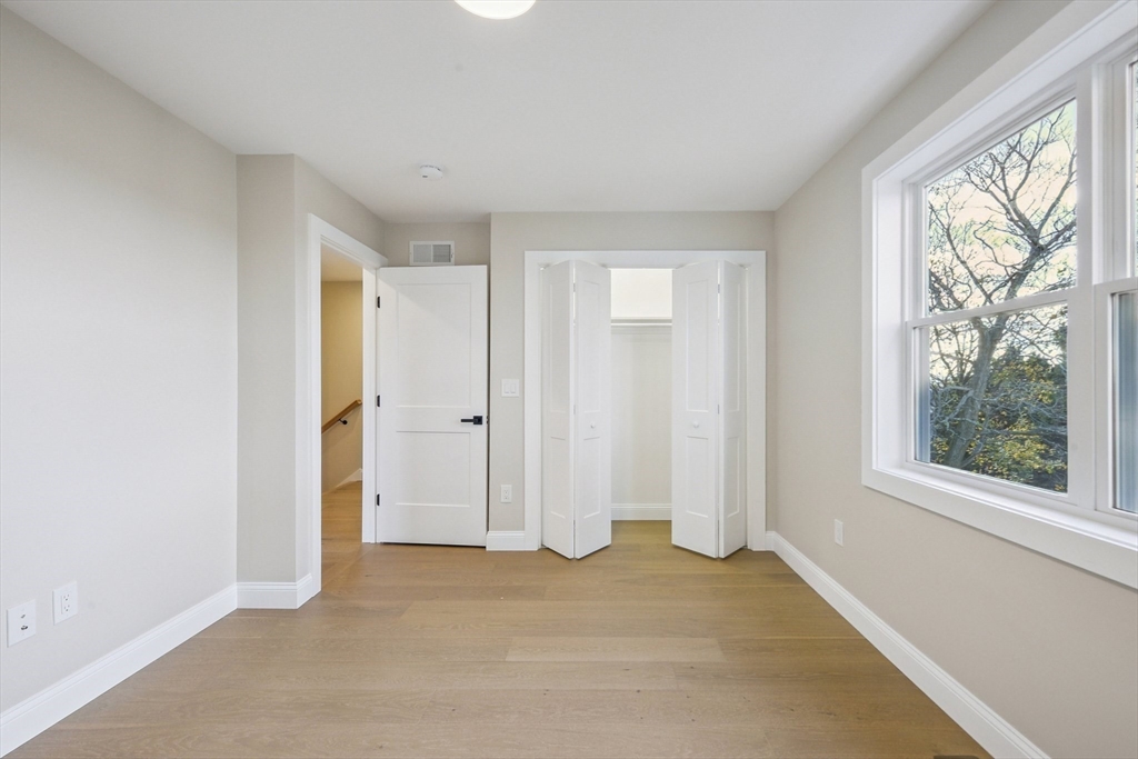 120 Stowe Street, Unit 120 Fall River, MA 02720 - Photo 12 of 21 wooden floor in an empty room with a window