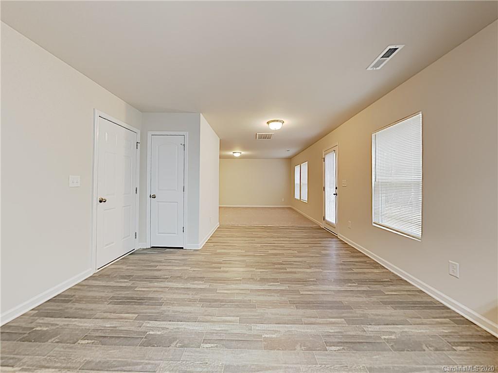 621 Buckskin Road Oakboro, NC 28129 - Photo 6 of 15 a view of an empty room with wooden floor and a window