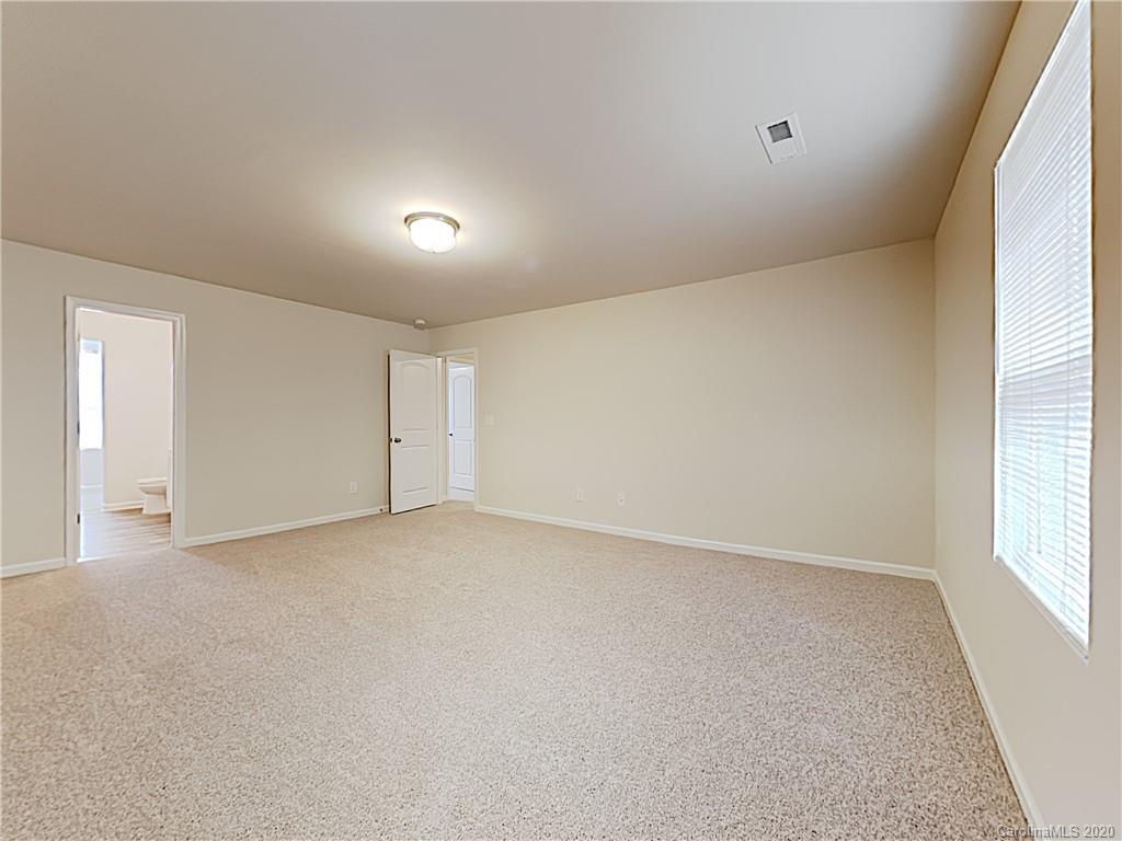 621 Buckskin Road Oakboro, NC 28129 - Photo 9 of 15 an empty room with a window and a projector screen