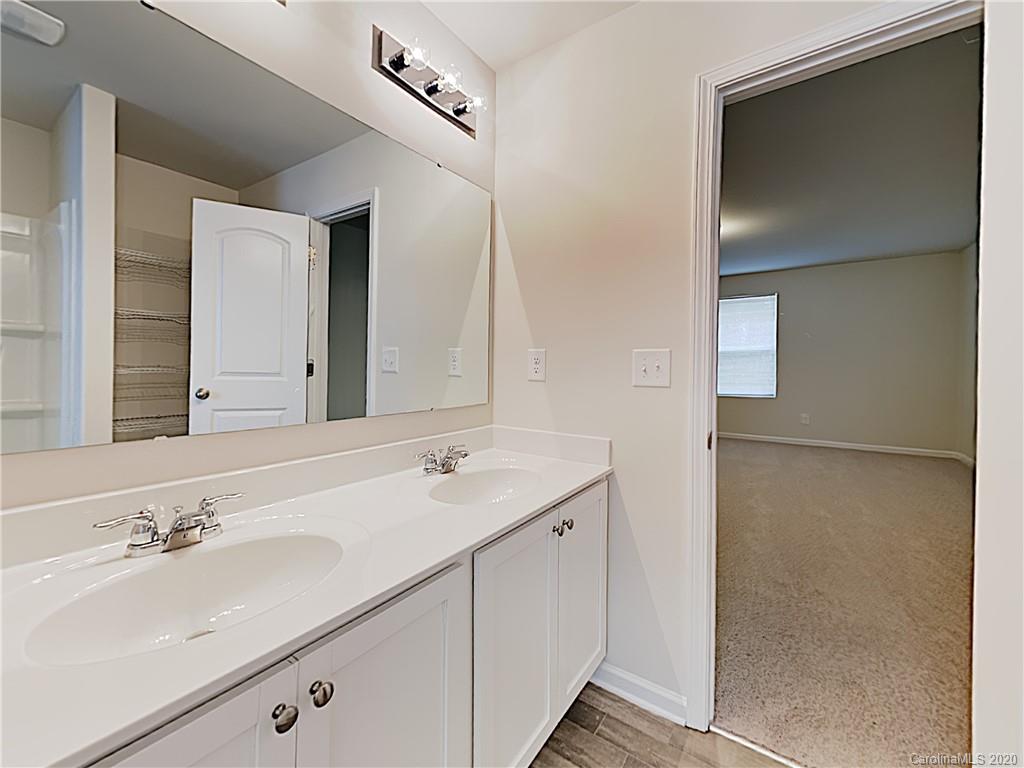 621 Buckskin Road Oakboro, NC 28129 - Photo 10 of 15 a bathroom with a double vanity sink and mirror