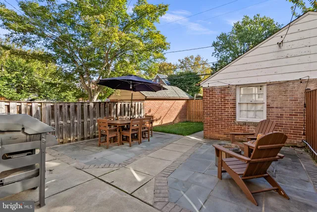 a view of backyard with outdoor seating a patio and plants
