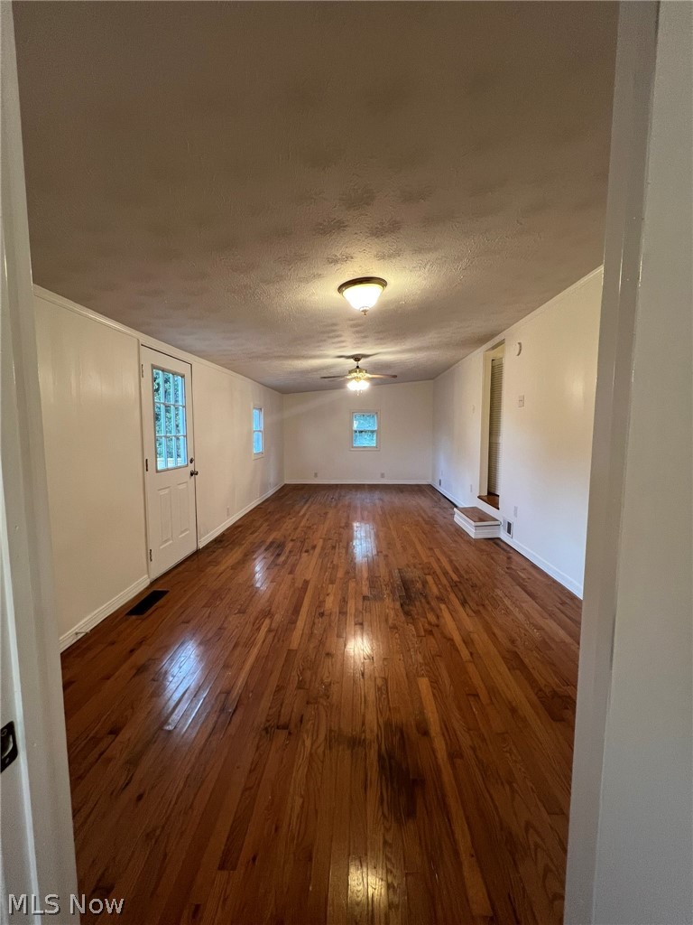 1105 Dutch Ridge Road Guysville, OH 45735 - Photo 21 of 33 Spacious room featuring wood-finish flooring, white paneled walls, and multiple ceiling light fixtures