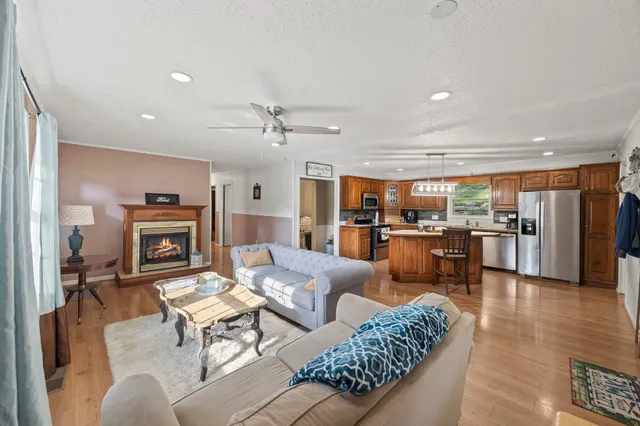 a kitchen with kitchen island a large counter top space and stainless steel appliances