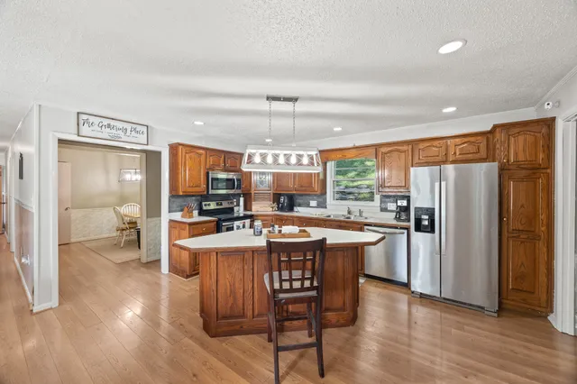 a kitchen with a sink a stove and cabinets