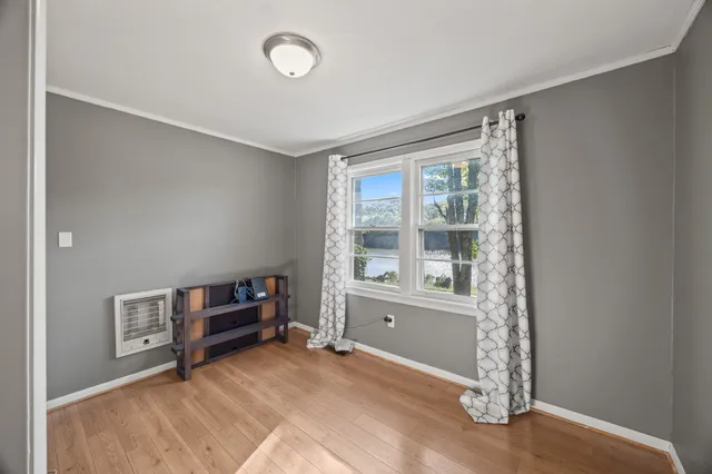 a spacious bedroom with a bed and a chandelier