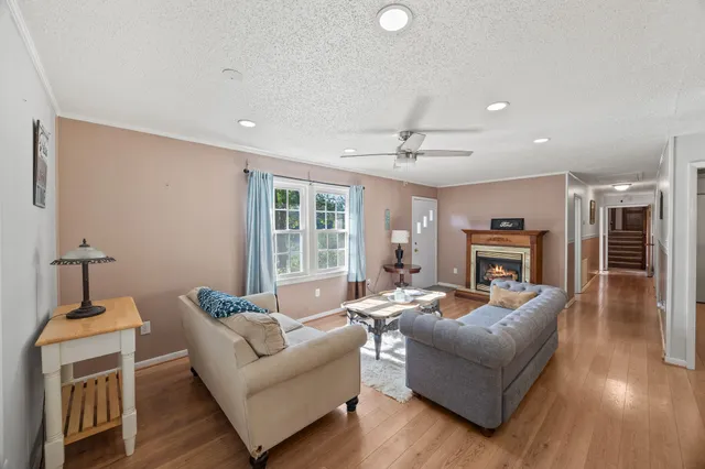 a living room with furniture and a wooden floor